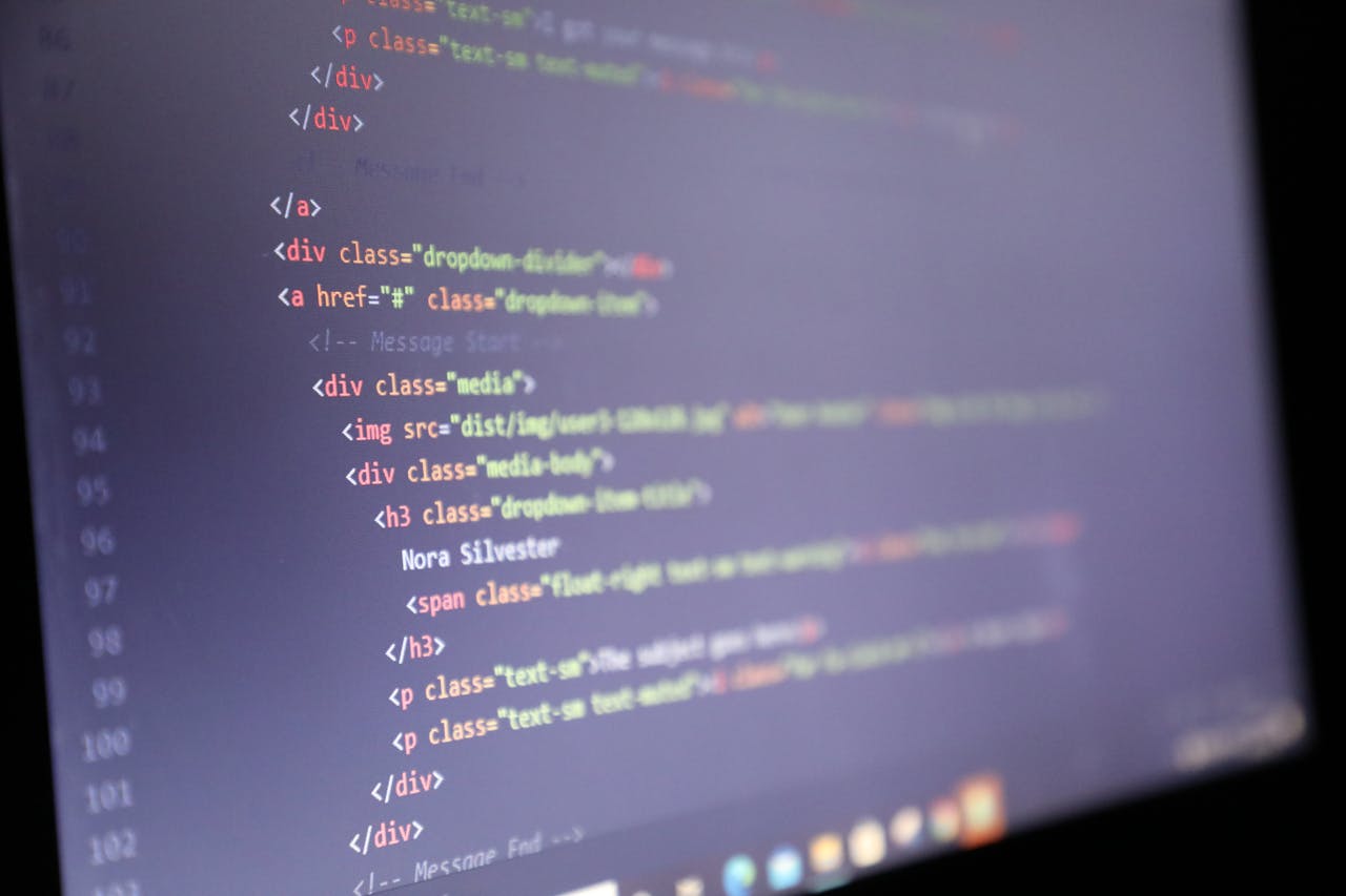 gallery-1 Illuminated HTML code displayed on a computer screen, close-up view.